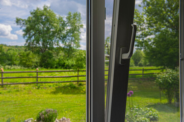 plastic window in the house is open for ventilation on a sunny day.