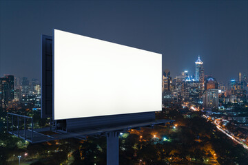 Blank white road billboard with Bangkok cityscape background at night time. Street advertising poster, mock up, 3D rendering. Side view. The concept of marketing communication to sell idea.