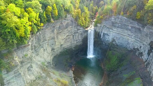 Aerial view of a waterfall in a canyon during early sunset in autumn in New York