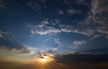 Summer sunset sky with fleece colorful clouds. Evening dusk good weather natural background.