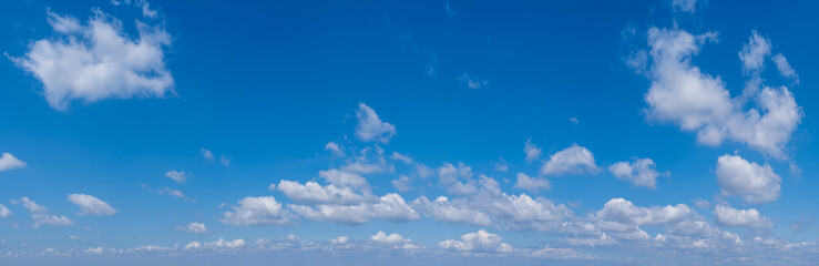 White cumulus clouds in blue sky panoramic high resolution background