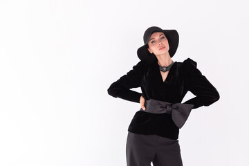 Young girl female model brunette in black hat on white background