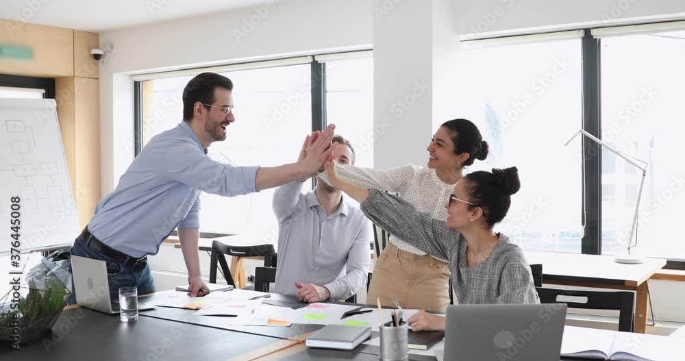 Poster motivated multicultural happy business people give high five at office meeting. african, caucasian a