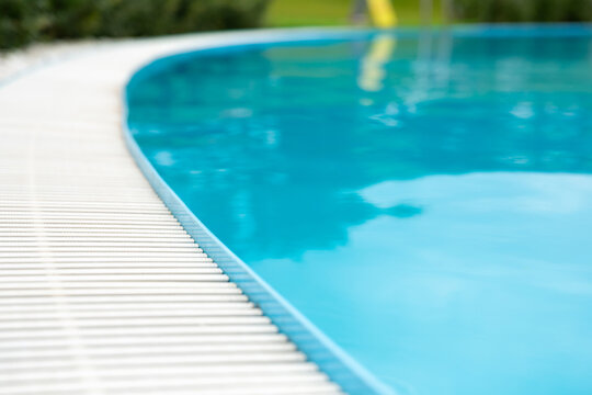 blue transparent pool water surface and white plastic side grating. For montage of your product.