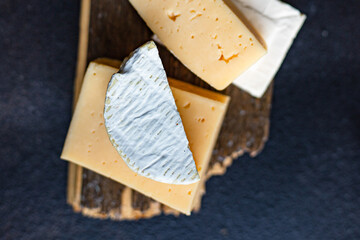 cheese assortment different types of hard and soft cheeses serving size raw natural milk top view copy space for text
