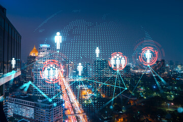 Glowing Social media icons on night panoramic city view of Bangkok, Asia. The concept of networking...