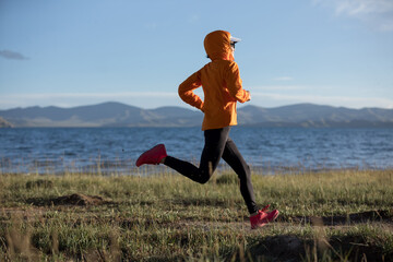 Woman trail runner cross country running outdoors