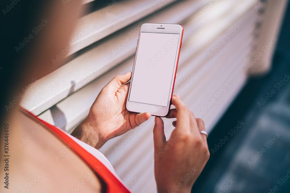 Poster cropped image of female millennial using cellular gadget with blank screen for download media file f