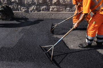 Paving the road with porous asphalt for traffic noise.reduction in Geneva, switzerland