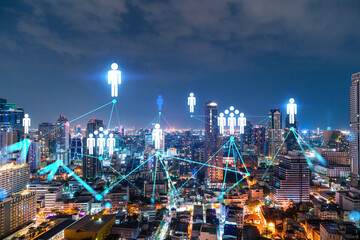 Fototapeta na wymiar Glowing Social media icons on night panoramic city view of Bangkok, Asia. The concept of networking and establishing new connections between people and businesses. Double exposure.