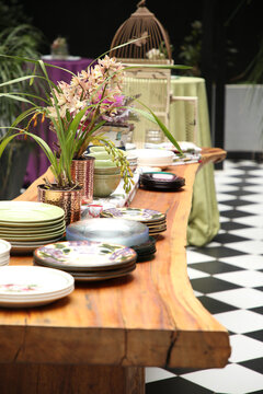 Plates Set Out On A Long Rustic Wooden Table.