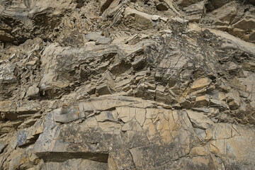 Stone background. Rock texture. Mountain surface texture. Close-up. Gray brown abstract natural rock background.