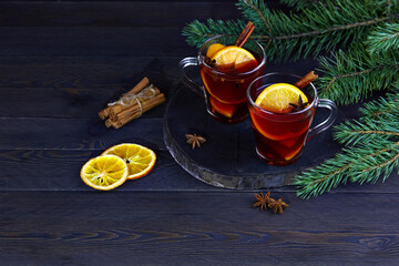 Obraz na płótnie Canvas Christmas hot mulled wine with cinnamon cardamom and anise on a wooden background
