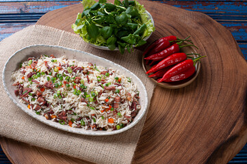 Arroz de Carreteiro - Typical food from southern Brazil, made with rice, dried meat, pepperoni sausage, bacon and carrots. Top view. Copy space