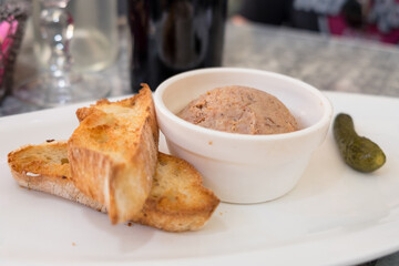 Luxury french snack - foie gras served with crispy toasted bread and pickled cucumbers © Veronika Kovalenko