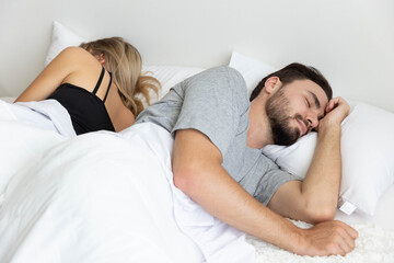 Obraz na płótnie Canvas A Couple has problem and sleep by turn back to each other