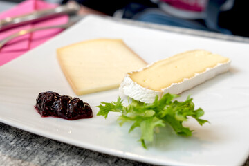 Traditional dessert of Languedoc-Roussillon (Occitanie) region of France - blue farm Brie cheese served with homemade fruit jam, fresh grapes or figs.