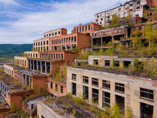 View from above. Ruined and abandoned buildings of a tin mining factory in the village of...