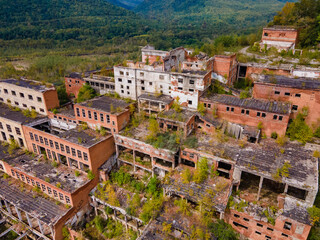 Fototapeta premium View from above. Ruined and abandoned buildings of a tin mining factory in the village of Kavalerovo. Khrustalnensky ore mining and processing plant