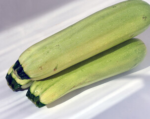 Green zucchini on a white background. Vegetarianism.