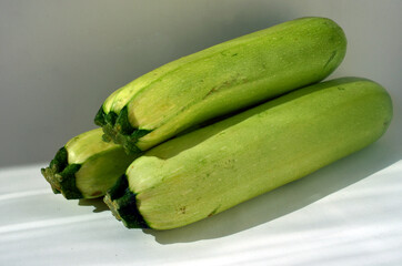 Green zucchini on a white background. Vegetarianism.