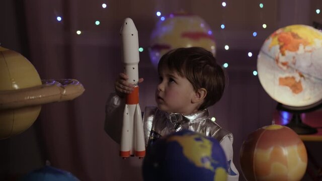 Space Travel Spaceship. Creative Little Kid Boy Astronaut Launching Rocket From Spaceport Through Planets. Child Dreamer Playing Toy Space Rocket Flying Among Planets. Spaceman Fantasy Flying on Space