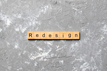 REDESIGN word made with wooden blocks concept