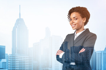Fototapeta na wymiar Smiling black African American business woman in suit in crossed arms pose. Kuala Lumpur cityscape. The concept of woman in business. KL skyscrapers. Double exposure.