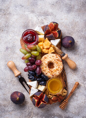 Appetizer for wine, cheese plate with grapes and figs