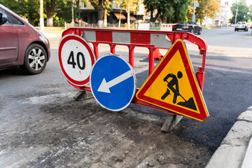 Road marking on the road, warning signs. Direction of detour, sign speed limit 40 and roadworks. Road signs denoting road repairs, speed limit up to 40, detour.