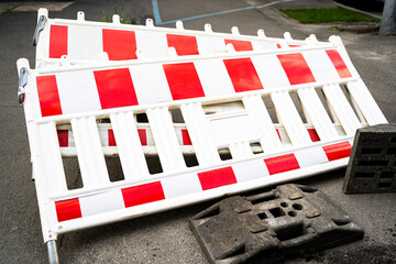 Fototapeta na wymiar barriers lie on the asphalt near the place where the builders are reconstructing the road surface