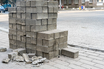 Repair on city streets. the replacement of the stone tiles on the road