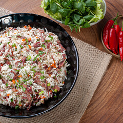 Arroz de Carreteiro - Typical food from southern Brazil, made with rice, dried meat, pepperoni sausage, bacon and carrots. Top view