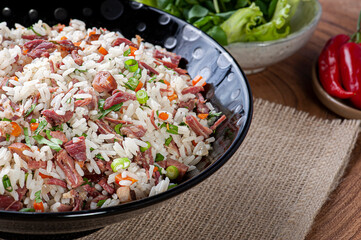 Arroz de Carreteiro - Typical food from southern Brazil, made with rice, dried meat, pepperoni sausage, bacon and carrots. Copy space