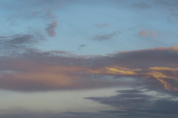 beautiful night sky with yellow, purple and gray clouds. Dramatic evening sky.