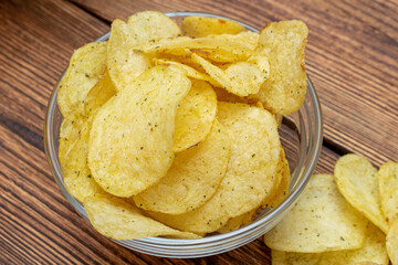 lot of yellow potato chips in glass dish