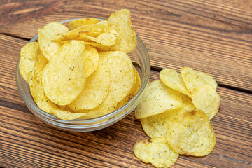 lot of yellow potato chips in glass dish