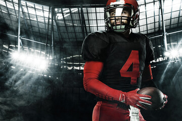 Closeup portrait of american football player, athlete sportsman in red helmet on grand arena...