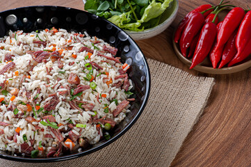 Arroz de Carreteiro - Typical food from southern Brazil, made with rice, dried meat, pepperoni sausage, bacon and carrots. Copy space