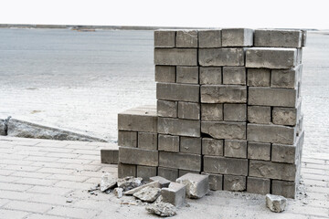 paving stones on the street. Pallets with folded paving slabs grey color.