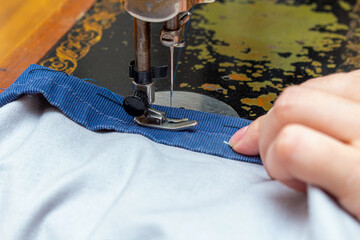 Stitching, sewing on an old, retro, vintage sewing machine close up