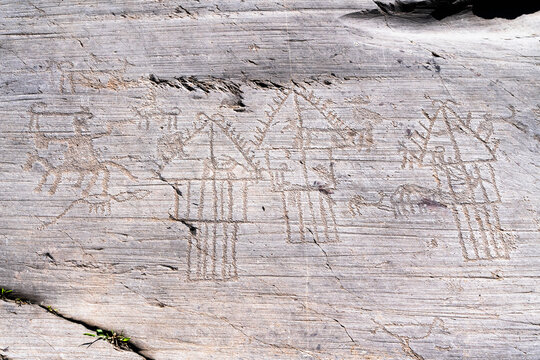 Camunian village with hut and barns or pantries engraved on rock 35, Naquane National Park, Valcamonica (Val Camonica, Lombardy