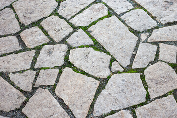 granite pavement with moss in the cracks background