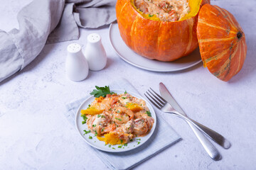 Pumpkin stuffed with shrimps and cheese, whole baked. Traditional Brazilian dish. Close-up.