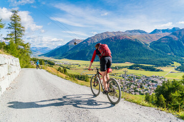 Mountain bikers on downhill path towards Celerina, Engadine, canton of Graubunden, Switzerland