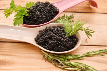 Black caviar with fresh herbs