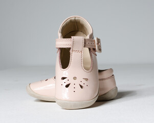 cute little vintage retro pink baby dolly shoes, isolated on a white studio background.  Tiny baby...