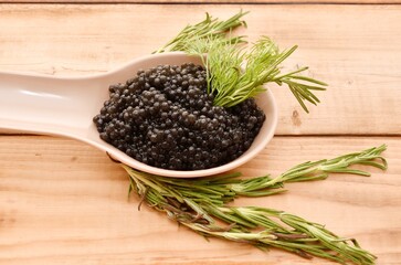 Black caviar with fresh herbs