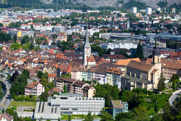 Fototapeta na wymiar Aerial view of Chur townscape overlooking reformed church of St. Martin and Catholic Cathedral on summer day, canton of Graubunden, Switzerland..