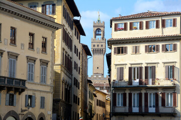 Fototapeta na wymiar The historic buildings of Piazza Santa Croce in Florence and in the background the tower of Arnolfo overlooking Palazzo Vecchio in Piazza della Signoria.